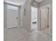 Inviting foyer with a white front door, neutral paint, and seamless tile flooring throughout at 1600 Spray Ter, St Cloud, FL 34771