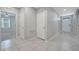 Bright hallway with neutral tile flooring and doors to bedrooms, offering a clean and welcoming entrance at 1600 Spray Ter, St Cloud, FL 34771