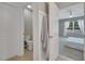 Bright hallway view to half bathroom and bedroom with neutral walls and tiled floors at 1600 Spray Ter, St Cloud, FL 34771