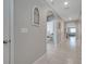 Inviting hallway with arched doorways and neutral tile floors leads to the living spaces at 1600 Spray Ter, St Cloud, FL 34771