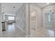 Hallway leads to the laundry room, living space, and bedroom, all with tiled flooring at 1600 Spray Ter, St Cloud, FL 34771