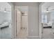 Hallway view showcasing access to two bedrooms and a bathroom, with neutral walls and tile flooring at 1600 Spray Ter, St Cloud, FL 34771