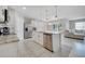 Open kitchen with a central island, stainless steel appliances, and access to the living area at 1600 Spray Ter, St Cloud, FL 34771