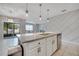 Stylish kitchen with a center island, pendant lighting, and a view of the living area at 1600 Spray Ter, St Cloud, FL 34771