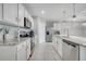 Modern kitchen featuring white cabinetry, stainless steel appliances, and a pantry for storage at 1600 Spray Ter, St Cloud, FL 34771