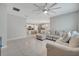 Open-concept living room with a large sectional couch, adjacent to the kitchen at 1600 Spray Ter, St Cloud, FL 34771