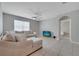 Bright living room with neutral tones, ceiling fan and a comfortable sectional couch at 1600 Spray Ter, St Cloud, FL 34771