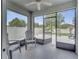 Enclosed patio featuring outdoor seating and a view of the backyard and white privacy fence at 1600 Spray Ter, St Cloud, FL 34771