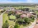 Breathtaking aerial perspective of the community showcasing meticulously landscaped grounds and picturesque greenery at 16049 Volterra Pt, Bella Collina, FL 34756
