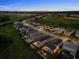 Night aerial view captures the community layout with houses, pools, and tree-lined streets at 16049 Volterra Pt, Bella Collina, FL 34756