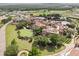 An aerial view of a charming neighborhood of upscale homes surrounded by trees at 16049 Volterra Pt, Bella Collina, FL 34756