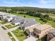 Aerial view of an upscale neighborhood with beautifully manicured lawns and landscaping at 16049 Volterra Pt, Bella Collina, FL 34756