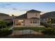 The back exterior features a covered patio, fenced yard, and a cozy outdoor seating area at 16049 Volterra Pt, Bella Collina, FL 34756
