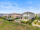 Upscale backyard with black aluminum fence and view of other upscale homes in the community at 16049 Volterra Pt, Bella Collina, FL 34756