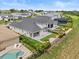 Aerial view of a fenced backyard with a patio, outdoor grill, palm trees and lush landscaping at 16049 Volterra Pt, Bella Collina, FL 34756