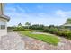 This backyard features a patio and a patch of grass surrounded by a fence at 16049 Volterra Pt, Bella Collina, FL 34756