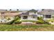 Fenced backyard featuring a covered patio, green lawn, and beautiful landscaping for outdoor enjoyment at 16049 Volterra Pt, Bella Collina, FL 34756