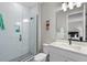 Clean bathroom featuring a glass shower, white vanity, and modern fixtures at 16049 Volterra Pt, Bella Collina, FL 34756