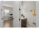 Half-bath located off of the home office features a modern sink and neutral paint at 16049 Volterra Pt, Bella Collina, FL 34756