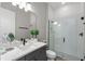 Modern bathroom featuring a glass shower, sleek vanity, and neutral color palette at 16049 Volterra Pt, Bella Collina, FL 34756