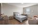 This cozy bedroom is furnished with a full size bed, a table, and chairs at 16049 Volterra Pt, Bella Collina, FL 34756