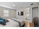 Bedroom with a television, wood-look floors, and an ensuite bathroom at 16049 Volterra Pt, Bella Collina, FL 34756