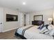 Cozy bedroom with a television, wood floors, and plenty of room for storage at 16049 Volterra Pt, Bella Collina, FL 34756