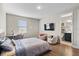 Comfortable bedroom with a queen bed, TV, and an en-suite bathroom with modern fixtures at 16049 Volterra Pt, Bella Collina, FL 34756