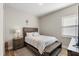 Comfortable bedroom with a queen bed, soft lighting, and hardwood floors at 16049 Volterra Pt, Bella Collina, FL 34756