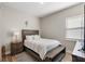 Neutral bedroom with light coming in through a window and warm-toned wood floor at 16049 Volterra Pt, Bella Collina, FL 34756