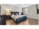 Well-lit bedroom featuring wood floors, large bed, and ample closet space at 16049 Volterra Pt, Bella Collina, FL 34756