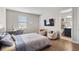 This cozy bedroom is furnished with a full size bed, a television, and chairs at 16049 Volterra Pt, Bella Collina, FL 34756