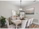 Dining area with modern chandelier, seating for six, large mirrors and artwork at 16049 Volterra Pt, Bella Collina, FL 34756