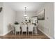 Formal dining area with a modern chandelier, seating for six, and elegant decor at 16049 Volterra Pt, Bella Collina, FL 34756