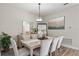 Bright dining room with stylish table and chairs, adjacent to a sideboard at 16049 Volterra Pt, Bella Collina, FL 34756