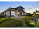 Exterior view highlighting the outdoor kitchen and landscaping with spacious backyard at 16049 Volterra Pt, Bella Collina, FL 34756