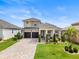 Beautiful two-story home featuring a manicured lawn and a spacious two-car garage at 16049 Volterra Pt, Bella Collina, FL 34756