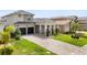Beautiful home showcasing a well-manicured lawn, driveway, and a spacious two-car garage at 16049 Volterra Pt, Bella Collina, FL 34756