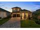 Charming two-story home boasts a manicured lawn and a convenient two-car garage at 16049 Volterra Pt, Bella Collina, FL 34756