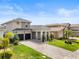 A beautiful two-story gray home with a two-car garage and lush landscaping, offering curb appeal at 16049 Volterra Pt, Bella Collina, FL 34756