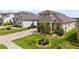 A well-manicured front yard with mature trees and landscaping at 16049 Volterra Pt, Bella Collina, FL 34756