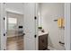 A view of an office and half bath, highlighting the wood flooring throughout the home at 16049 Volterra Pt, Bella Collina, FL 34756