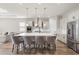 Stylish kitchen featuring a large island with bar seating, stainless steel appliances, and modern pendant lighting at 16049 Volterra Pt, Bella Collina, FL 34756