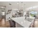 Bright, open kitchen with white countertops, stainless steel appliances, and pendant lighting at 16049 Volterra Pt, Bella Collina, FL 34756