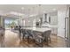 Bright kitchen with an island, stainless steel appliances, and an adjacent living space at 16049 Volterra Pt, Bella Collina, FL 34756