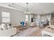 Bright, open-concept living room features a comfortable sofa and modern decor at 16049 Volterra Pt, Bella Collina, FL 34756