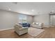 Bright living room featuring hardwood floors, comfortable sofas, and ample natural light at 16049 Volterra Pt, Bella Collina, FL 34756