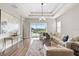 Inviting living room with plush seating, elegant decor, and a seamless connection to the outdoor patio at 16049 Volterra Pt, Bella Collina, FL 34756