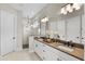 Beautiful main bathroom with double sinks, walk-in shower, and a neutral color palette at 16049 Volterra Pt, Bella Collina, FL 34756