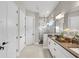 A spacious main bathroom with dual sinks, modern shower, updated fixtures, and natural light at 16049 Volterra Pt, Bella Collina, FL 34756